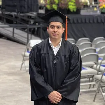 Headshot of Manuel Diaz wearing a cap and gown.